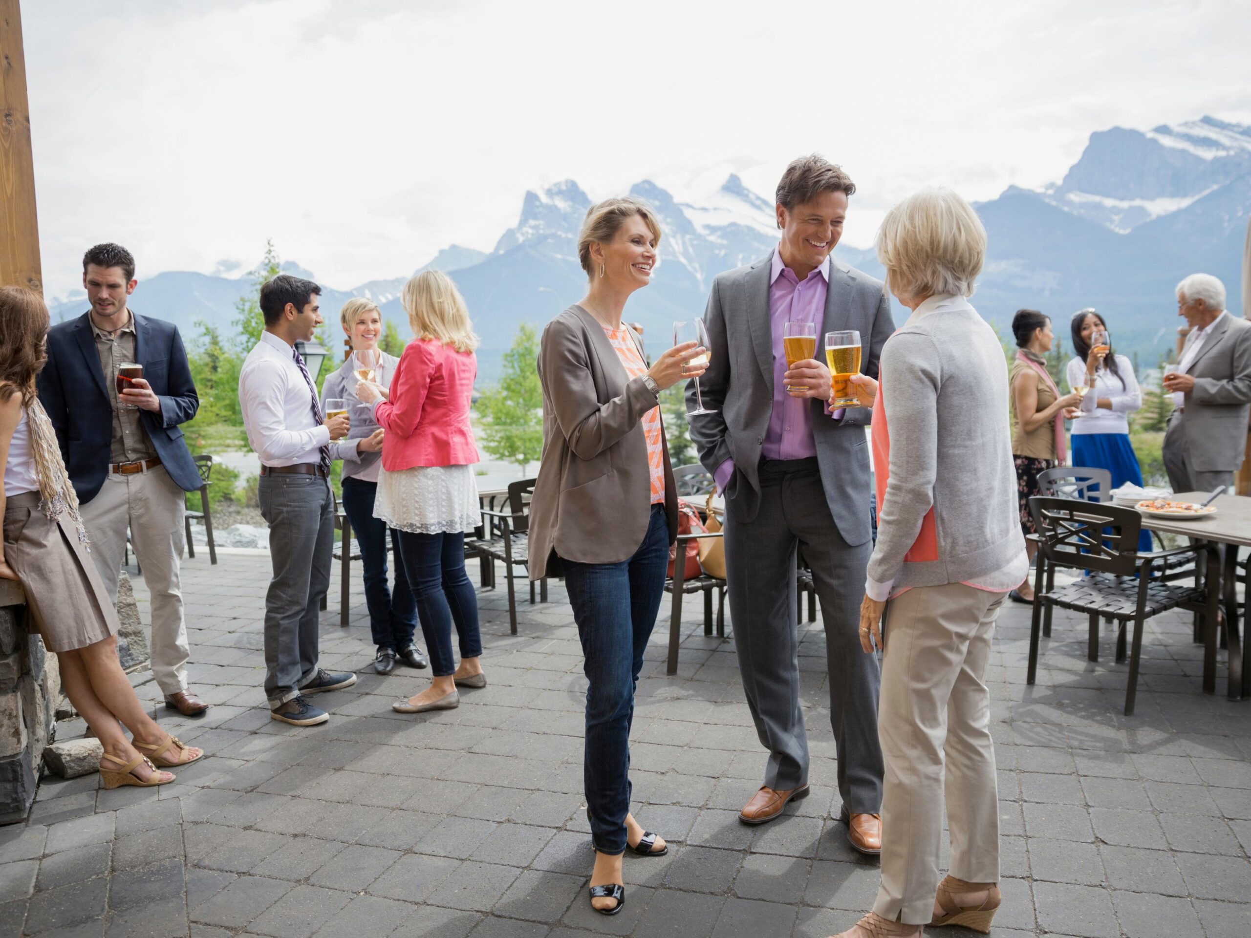 Friends mingling with drinks at an outdoor social event